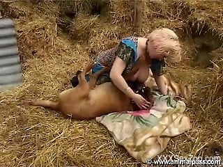 Sensual mature blonde fucks with a big trained doggy at the ha...
